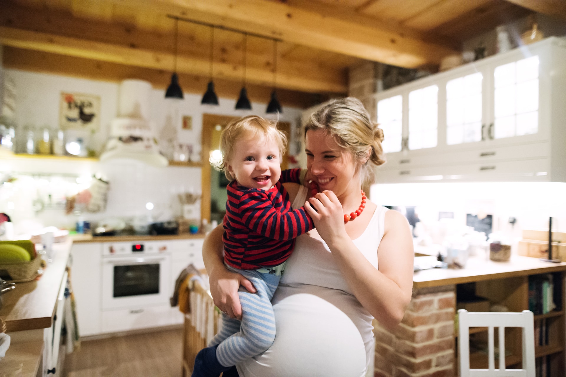 Expectant mother at home with her toddler